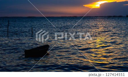 Sunset reflections calm water coastal landscape serene environment wide view nature's beauty 127414551