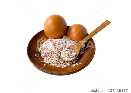 Broken or Crushed Egg Shells on Wood plate. Broken or Crushed Egg Shells on Wood plate. 127416187