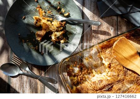 A dirty plate with the remains of a slice of shepherd's pie or meat pie A dirty plate with the remains of a slice of shepherd's pie or meat pie 127416662