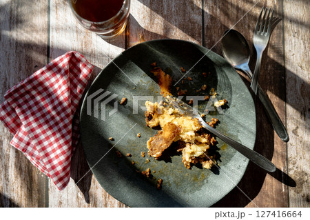 A dirty plate with the remains of a slice of shepherd's pie or meat pie A dirty plate with the remains of a slice of shepherd's pie or meat pie 127416664