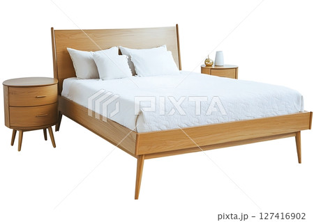 A wooden bed with a white comforter and pillows 127416902