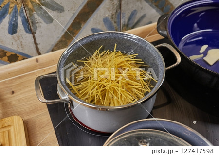 Cooking dinner with pasta at home Cooking dinner with pasta at home 127417598