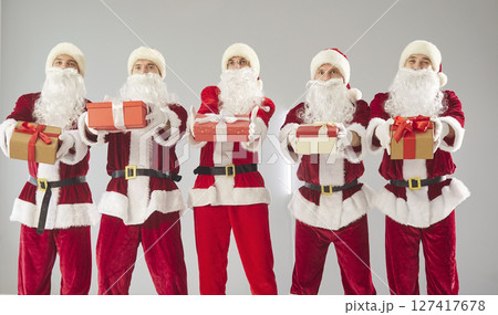 Happy New Year cute group presenting gift box, partying fun wearing Santa Claus holiday costumes 127417678