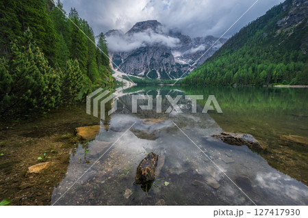Beautiful alpine lake Braies and mountains in low clouds 127417930