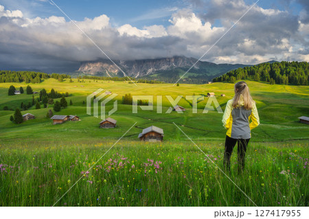 Young woman on the meadow with yellow flowers and green grass 127417955