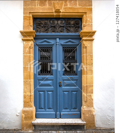 Elegant blue wooden door with ornate wrought iron details in nicosia, cyprus 127418054