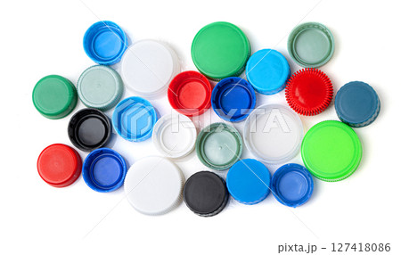Colorful plastic bottle caps forming a pattern on white background Colorful plastic bottle caps forming a pattern on white background 127418086