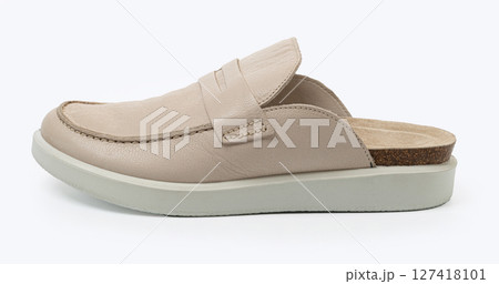 Beige leather loafer mule combining comfort and style on white background 127418101