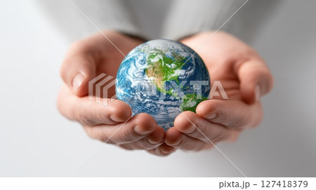 Hands Gently Cradling a Miniature Earth Representing Care and Sustainability 127418379