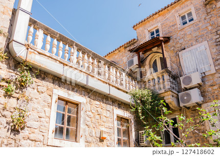 Historic stone building with classic balustrade and rustic charm. Mediterranean architecture, cultural heritage, and everyday European beauty. 127418602