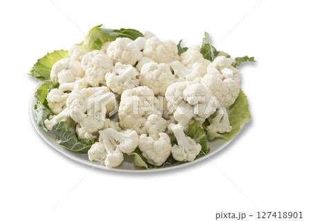 Fresh and raw cauliflower on the white plate. The cauliflower - vegetable is cut into pieces on white background. The vegetable is divided into inflorescences on the plate Fresh and raw cauliflower on the white plate. The cauliflower - vegetable is cut into pieces on white background. The vegetable is divided into inflorescences on the plate 127418901