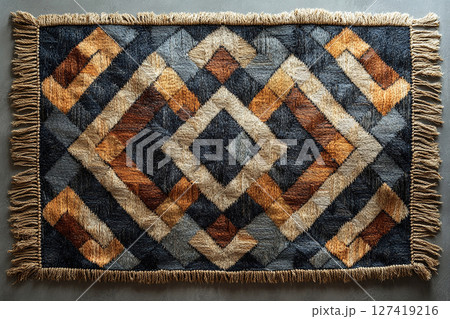 Handwoven rug texture with geometric print on a white background. Top view. 127419216