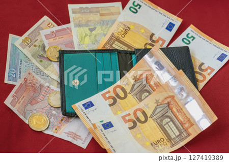 Wallet with euro and Bulgarian lev banknotes and coins on red background. Bulgaria, transition to Euro, finance and budgeting. Concept of personal money, savings, financial international spending Wallet with euro and Bulgarian lev banknotes and coins on red background. Bulgaria, transition to Euro, finance and budgeting. Concept of personal money, savings, financial international spending 127419389