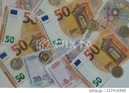 Mixed euro and Bulgarian leva banknotes, coins. Currency mix illustrates concept of exchange, finance and economy. Bulgaria joining euro zone, exchange of Bulgarian lev money for Euro Mixed euro and Bulgarian leva banknotes, coins. Currency mix illustrates concept of exchange, finance and economy. Bulgaria joining euro zone, exchange of Bulgarian lev money for Euro 127419390