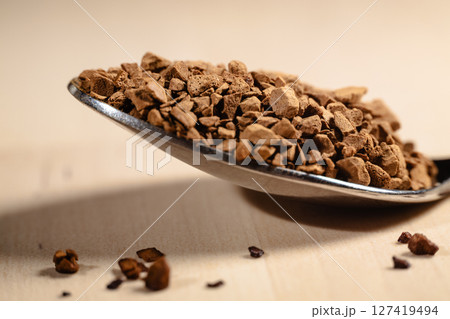 Spoonful of Instant Coffee Granules in Warm Light 127419494