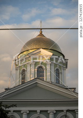 A clock tower in front of a building 127419935