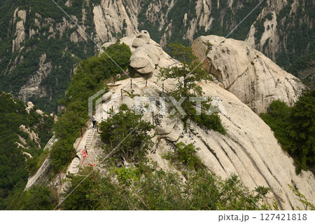 Mount Huashan is one of the most famous tourist attractions in China and one of the must-do activities is rock climbing and hiking. It is a sacred mountain, home to many deities. 127421818