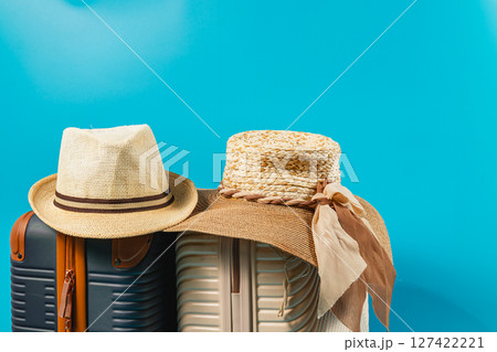 Summer travel essentials with stylish hats and luggage 127422221