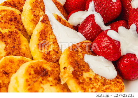 Delicious breakfast with pancakes and strawberries served Delicious breakfast with pancakes and strawberries served 127422233