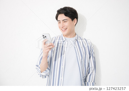 シャツを着た男性 スマホを持つ見る シャツを着た男性 スマホを持つ見る 127423257