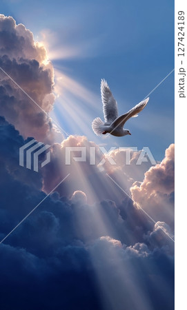 Majestic white dove soaring through sunlit clouds in serene sky. 127424189