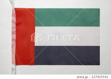 Closeup view of the United Arab Emirates national flag isolated over a white background. Concept of government and nationality 127425542