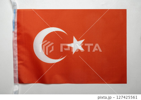 Closeup view of the Turkey national flag isolated over a white background. Concept of government and nationality 127425561