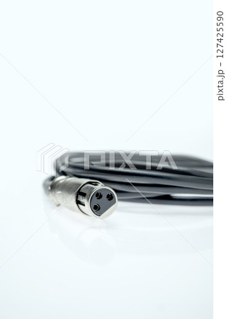 Closeup view of an audio jack cable on a white background. XLR audio cable Closeup view of an audio jack cable on a white background. XLR audio cable 127425590