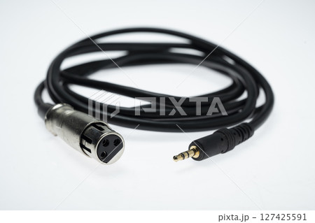 Closeup view of an audio jack cable on a white background. XLR audio cable Closeup view of an audio jack cable on a white background. XLR audio cable 127425591