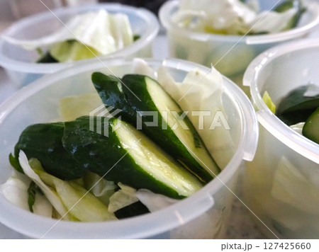 保存容器に小分けで入れられた塩もみした夏野菜（キャベツときゅうり）3＿ 127425660