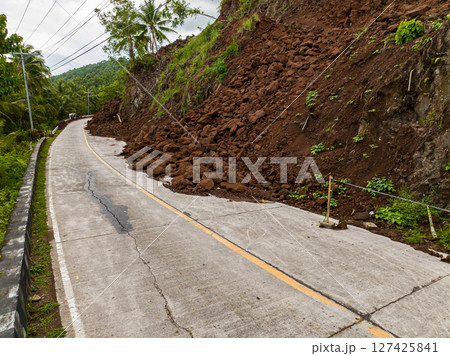 Landslides wiith rocks and soil block the highway due to heavy rainfall. Philippines. 127425841