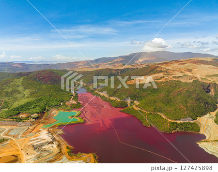 A dark red water in lake formation of nickel mine. Mining in an open pit. Mindanao, Philippines. 127425898