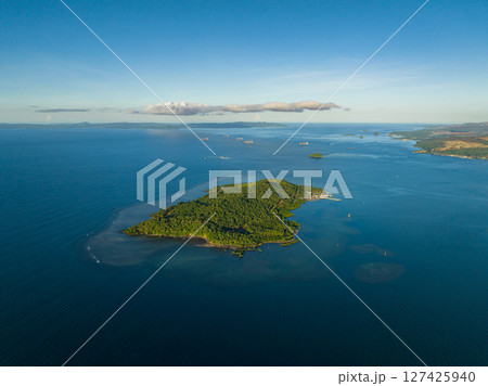 Drone view of Island surrounded by blue sea and coral reefs. Mindanao, Philippines. Seascape. 127425940