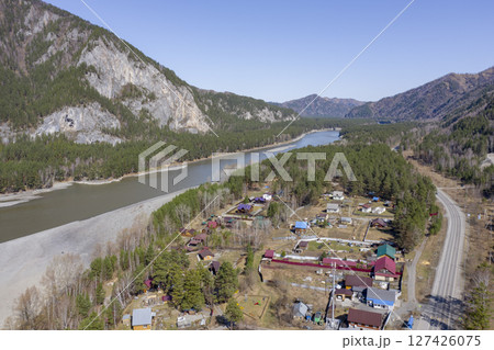 Aerial view of the village at the mountains, forest and the Katun River in the Altai Mountains Aerial view of the village at the mountains, forest and the Katun River in the Altai Mountains 127426075