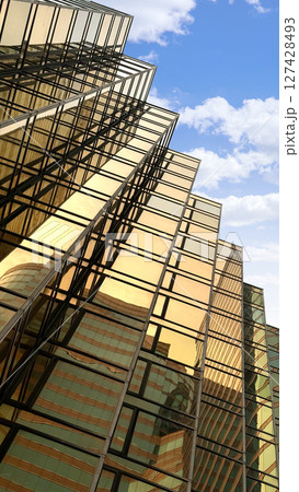 Gold exterior glass window commercial buildings with cloud and sky Gold exterior glass window commercial buildings with cloud and sky 127428493