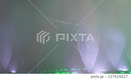 Water Fountain Lights Night Show: Atmospheric nighttime water feature display showcasing illuminated jets. Water Fountain Lights Night Show: Atmospheric nighttime water feature display showcasing illuminated jets. 127428827