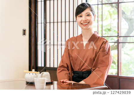旅館,料亭で日本茶を運ぶ女性スタッフ,仲居,女将 127429839