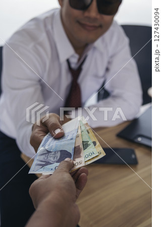 Close up hands giving money bribe payment. Hands holding dollar bill bribery financial economy business people. Business people corrupt illegal settlements try to pay graft. Corruption bribe concept 127430094