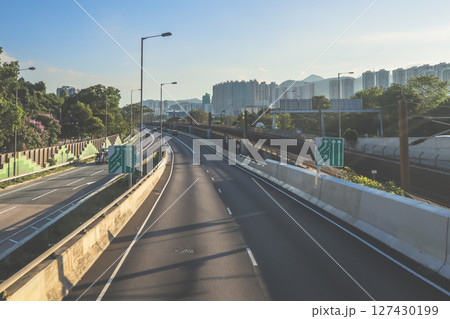 June 7 2025 Urban Highway View with Direction Signs and Mountainous Backdrop June 7 2025 Urban Highway View with Direction Signs and Mountainous Backdrop 127430199
