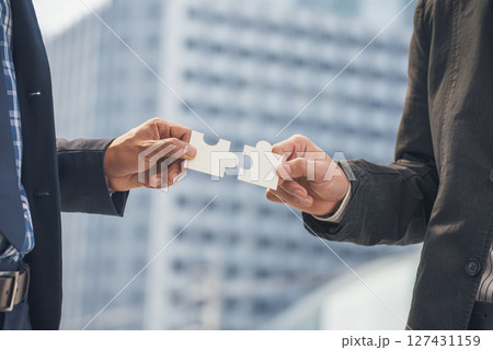 Unified synergy assembly business game implementation multiple puzzle meeting. Business connections strategy synergy team solution. Piece of jigsaw assembly by implement multiple game puzzle. Hands of 127431159