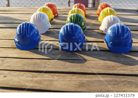 Construction hard hat safety tools equipment for workers in construction site for engineering protection head standard. Many hard hat helmet on row with copy space. Engineering Construction Concept 127431379