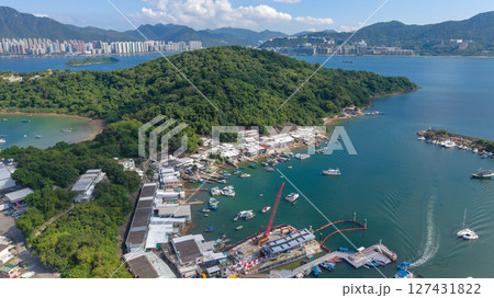 June 7 2025 Harbor View with Boats Docked and Mountainous Background Under Blue Sky 127431822