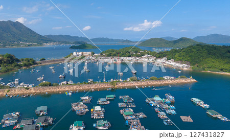 June 7 2025 Harbor View with Boats Docked and Mountainous Background Under Blue Sky June 7 2025 Harbor View with Boats Docked and Mountainous Background Under Blue Sky 127431827