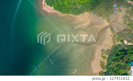 View of Coastline with Boats and Greenery in Crystal Clear Water View of Coastline with Boats and Greenery in Crystal Clear Water 127431832