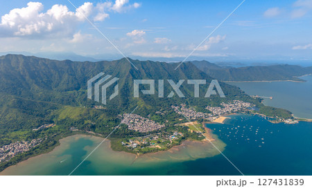 View of a Coastal Village with Surrounding Mountains and Clear Waters View of a Coastal Village with Surrounding Mountains and Clear Waters 127431839