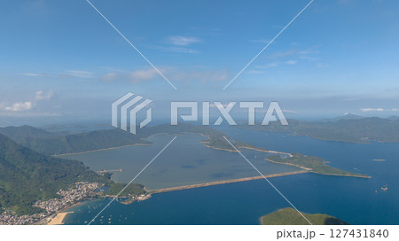a Serene Coastal Lagoon and Nearby Mountain Range a Serene Coastal Lagoon and Nearby Mountain Range 127431840