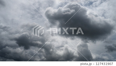 Dark rain cloud dramatic sky summer tropical thunder storm sky and fluffy black darkness cloud nearly raining cloudscape. Nimbus raincloud skyline climate background. Dark gray sky cloudy environment 127431907