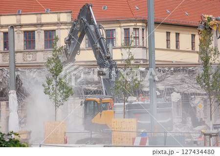 Close-up view of crumbling bridge structure demolition in Magdeburg Damaschkeplatz exposed steel rebar falling concrete chunks. Rubble piles and demolition machinery emphasize destruction progress Close-up view of crumbling bridge structure demolition in Magdeburg Damaschkeplatz exposed steel rebar falling concrete chunks. Rubble piles and demolition machinery emphasize destruction progress 127434480