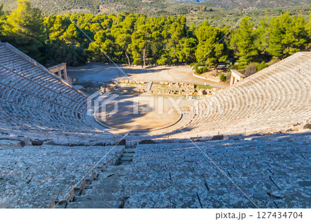 Ancient Theatre of Epidaurus is theatre in Greek city of Epidaurus, located on southeast end of sanctuary dedicated to the ancient Greek God of medicine, Asclepius in Peloponnese, Greece 127434704