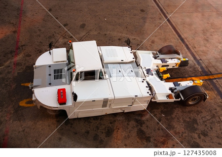 Aircraft Towing Tractor Ready on Airport Apron for Operation, Ground Support Equipment Aircraft Towing Tractor Ready on Airport Apron for Operation, Ground Support Equipment 127435008